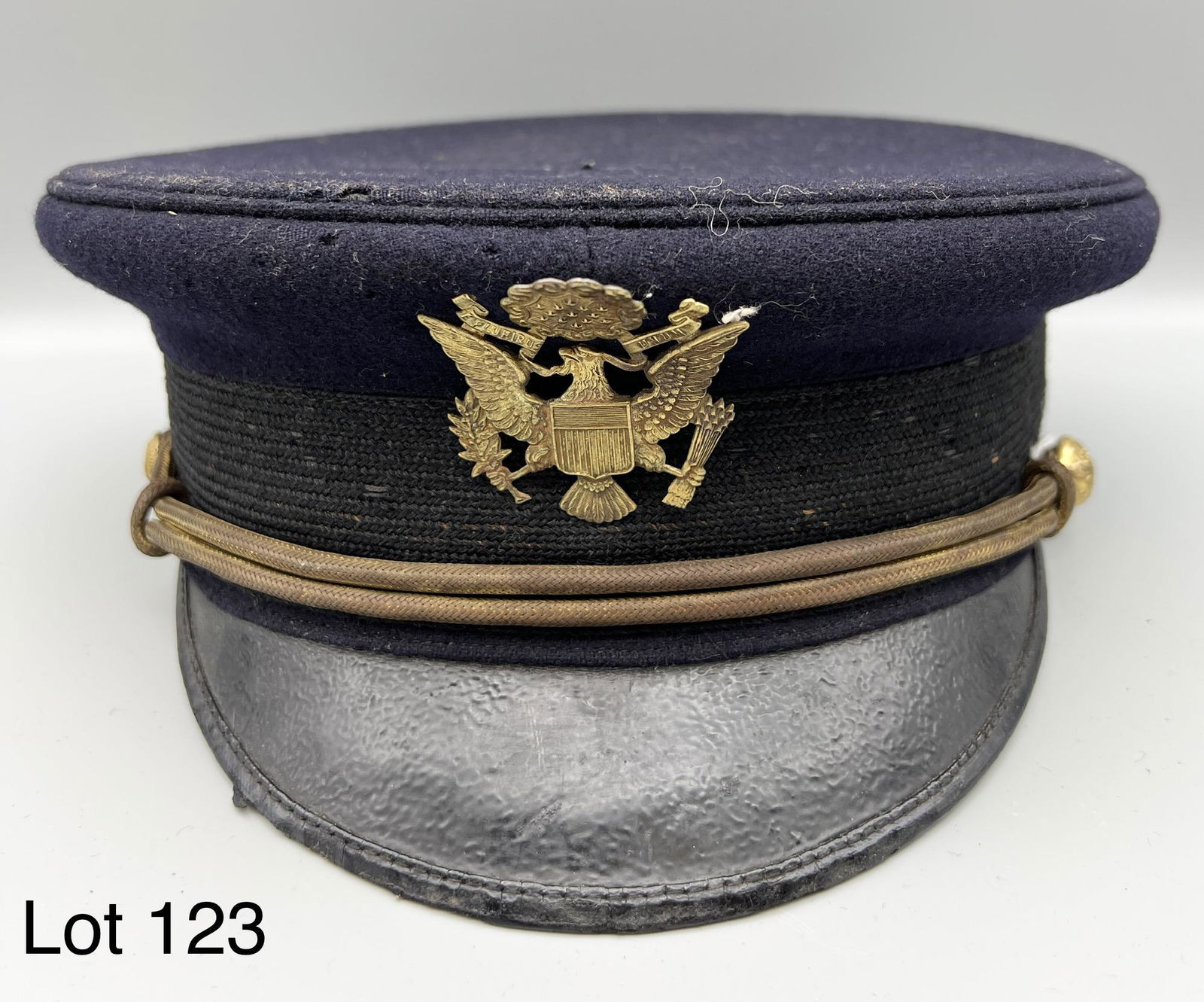 D. Klein & Bro. Officer's Cap: Navy blue military officer's cap with leather visor by D. Klein & Bro. of Philadelphia, PA. Blue wool, makers mark on interior. Measures 9 1/2" x 9 1/4" *notes - minor tears on top,