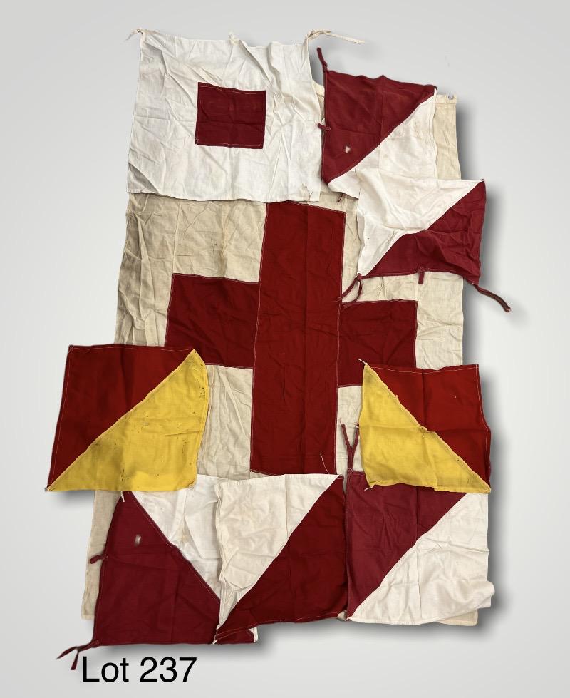 1940's Medical Red Cross Flags and Red Signal Flags: A group of vintage medical red cross flags and red signal flags the 1940's. Large red cross flag is 45" x 61". *notes- staining and holes throughout.