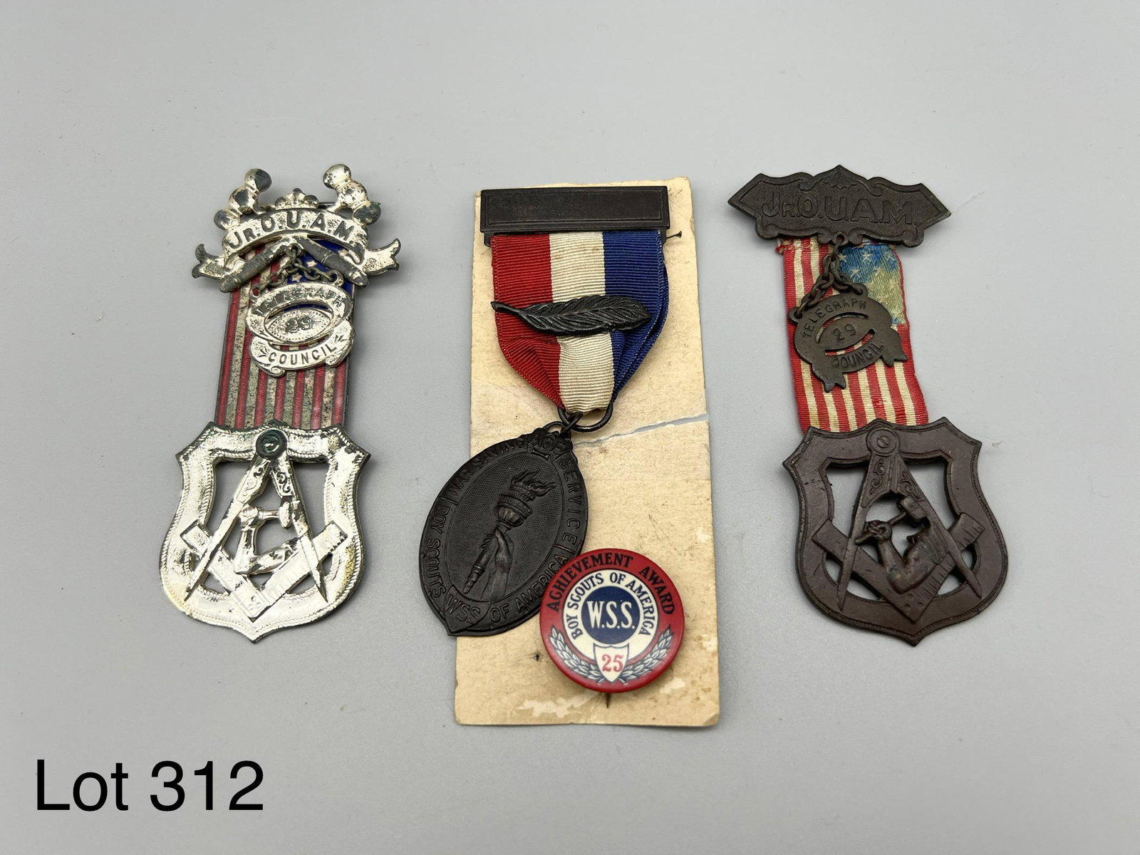 Lot of Youth Organization Medals: Lot of four award pins and medals for American organizations. Two noted from the Boy Scouts of America, one small button and one larger medal from the War Savings Service Committee. Other two are meda