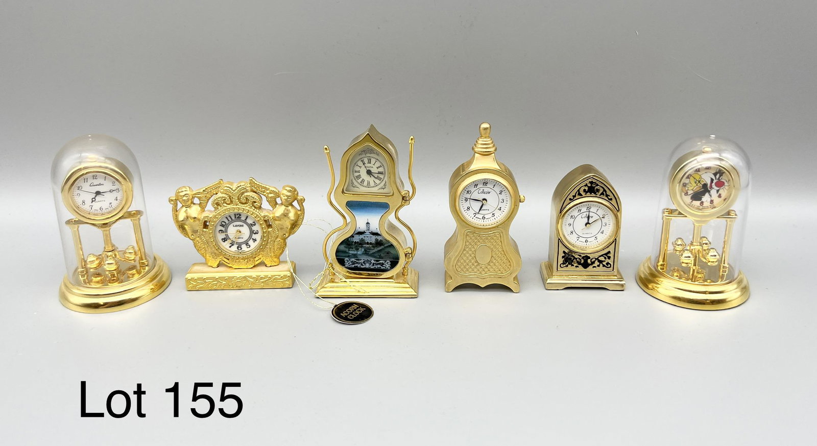 Lot of Miniature Clocks: Lot of 6 miniature clocks. Makers include Lavoni, Collezio, Quartex, Bulova and Warner Bros. Tallest is 2 1/2".