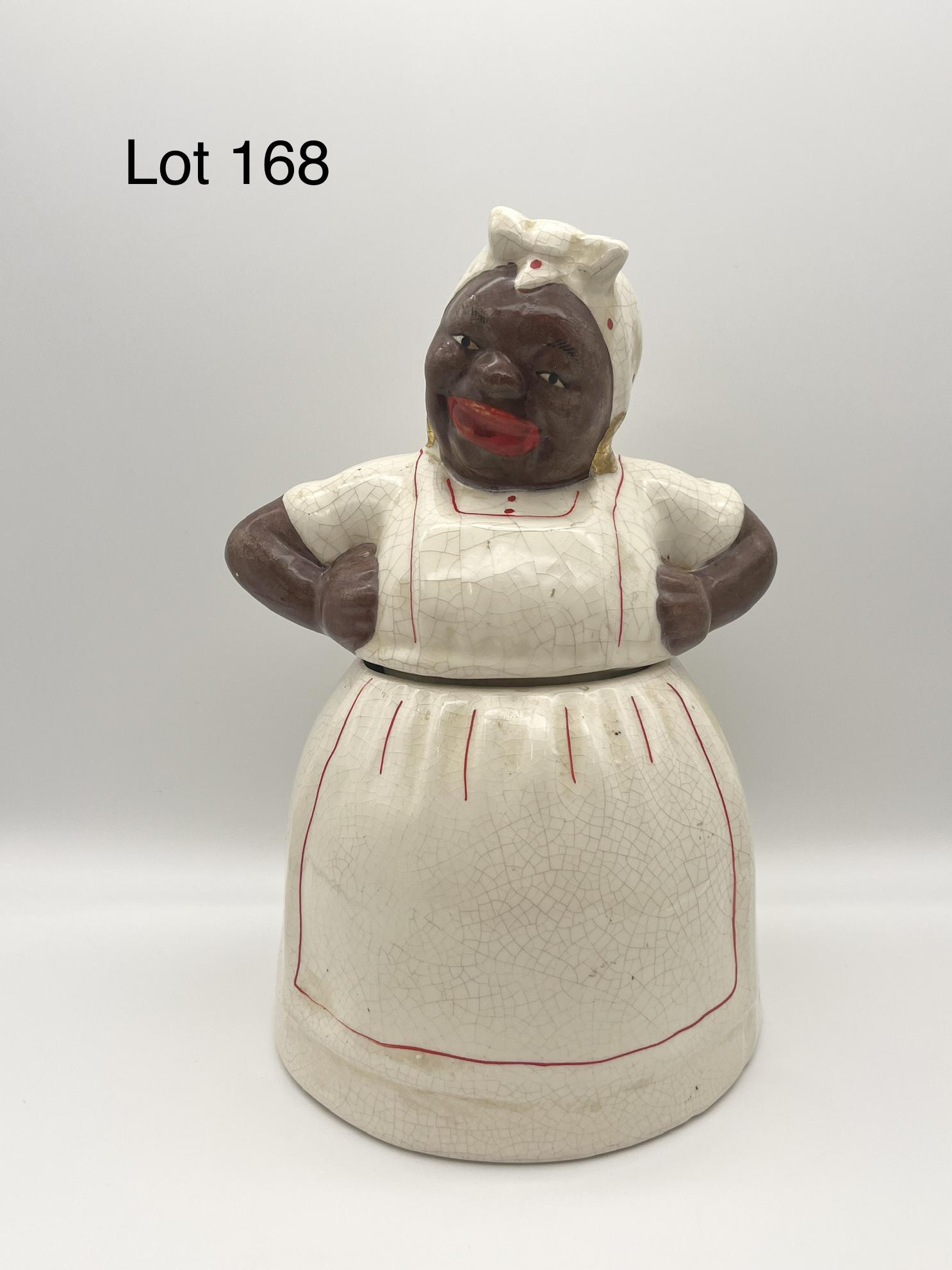 McCoy Aunt Jemima Cookie Jar: Ceramic "Mammy" cookie jar by McCoy, figure in white dress and apron. Makers mark on back, measures 11" tall. *notes - craquelure, lid does not fit perfectly