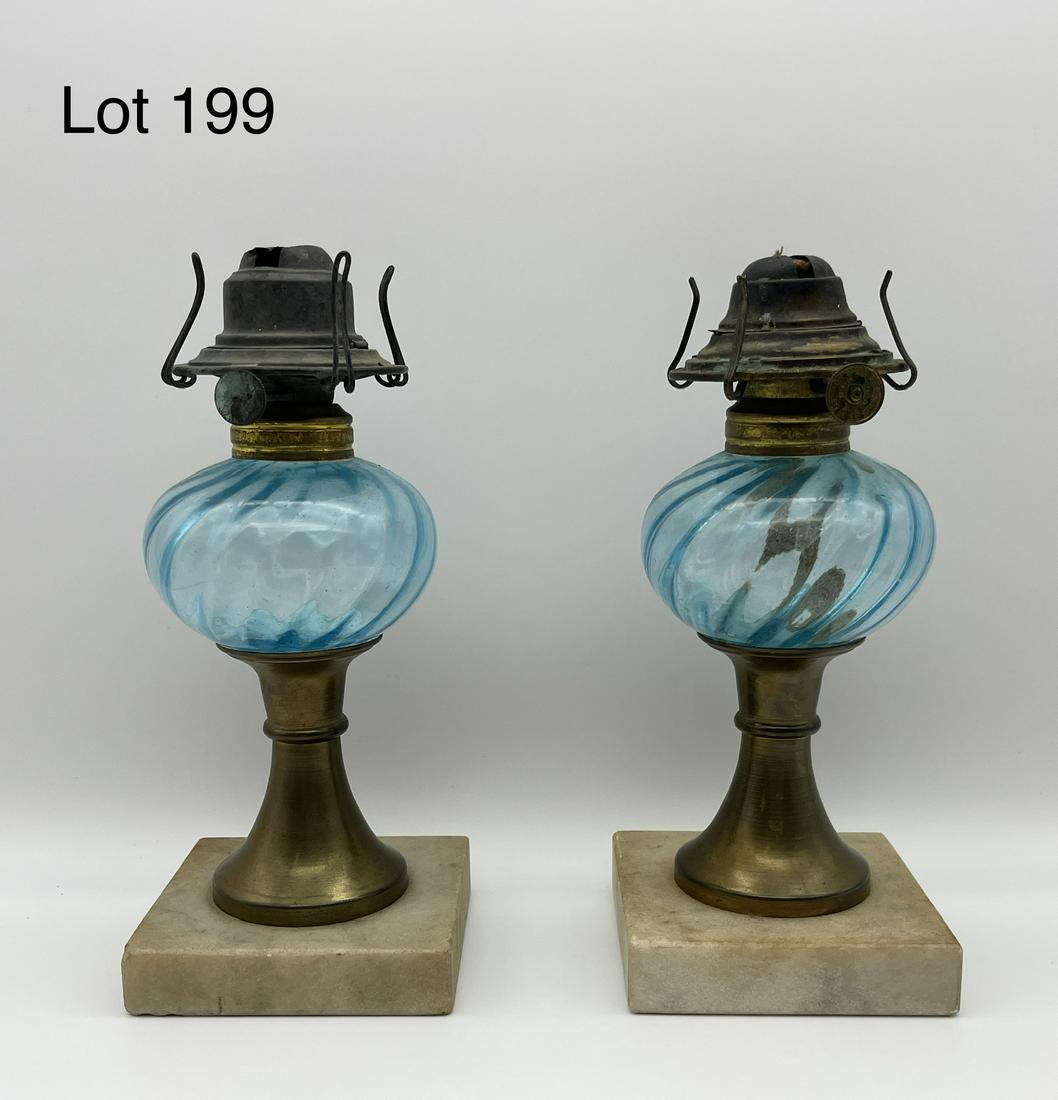 Pair of Mounted Blue Oil Lamps: Pair of kerosene oil lamps with hand blown blue glass, mounted on granite base. Makers mark on switch reads "Banner - P&A Mfg. Co." Measures 8" tall. *notes - one has no wick left