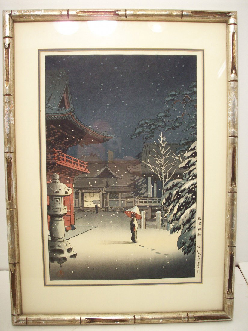 Tsuchiya Koitsu Woodblock 'Snow At Nezu Shrine': 15" X 10" matted in a 20" X 14 1/2" bamboo like wood frame. Tsuchiya Koitsu (1870-1949). This woodblock print is from 1934. Print does not lie flat. Excellent condition.