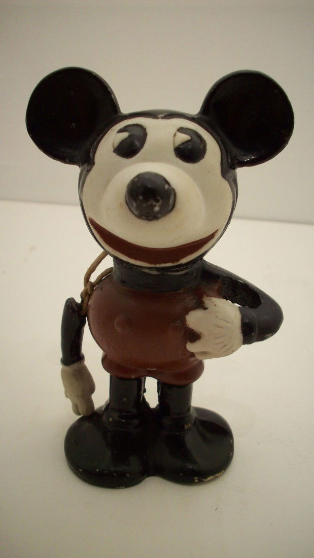 1930's Pie Eyed Mickey Mouse Bisque Figure: 5" tall. Bisque Mickey Mouse Figure with Pie Eyes and a movable arm, there is a pull string that control the moving right arm (original string has been repaired), belly is marked Mickey Mouse and on t