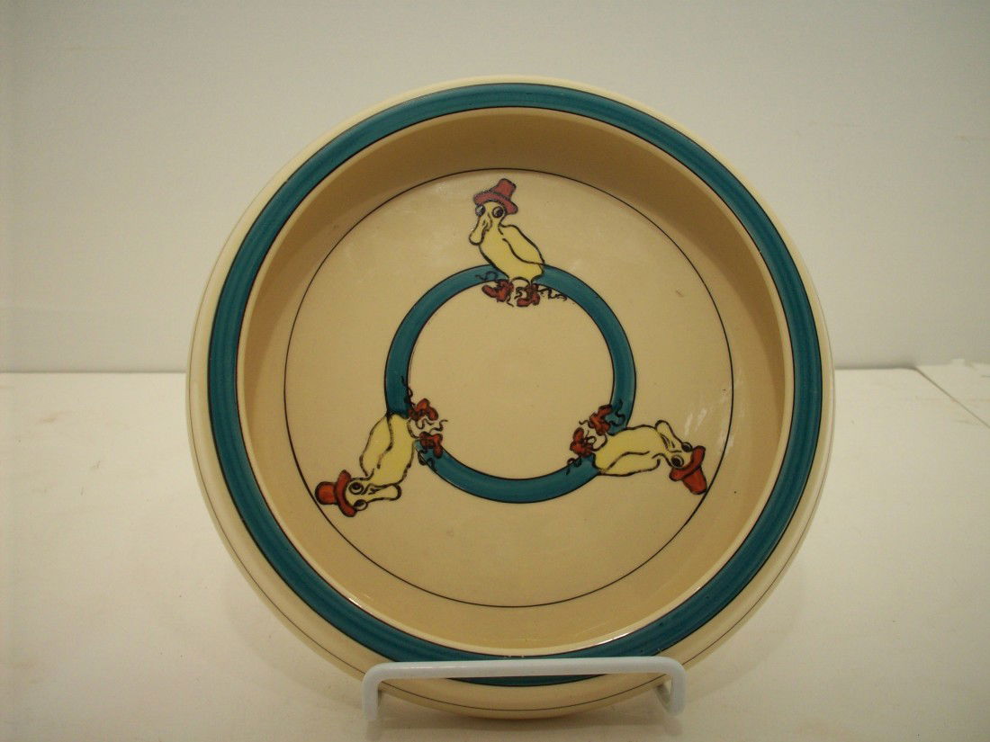 Roseville Pottery "Puddle Duck" Juvenile Bowl: 7 3/4" X 1 1/4" with a 6" rim. Roseville's Creamware line rolled-edge plate circa 1925 features the adorable and hard to find "Puddle Duck", with his bright red rain hat and boots. Condition is excell