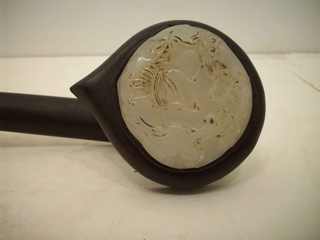Zi Tan with White Jade Ruyi: 14" long x 3 1/2" at widest, 2 3/4" white jade face with two birds and flowers. This wood and jade curved sceptre is in excellent condition with minor discoloration on the white jade.