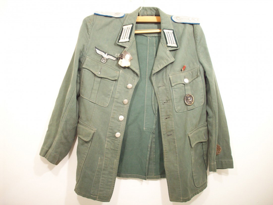 German Transportation Corps Uniform Tunic: Green tunic with a wounded badge and a ribbon bar. Great condition with minor fading.