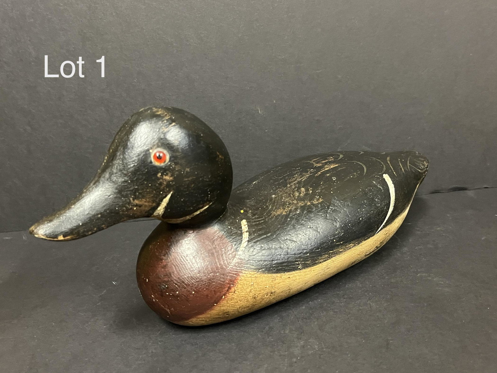 Mason Wood Duck Drake Decoy: A Mason decoy of a Wood Duck drake. Made of carved wood with glass eyes. Unsigned. Head likely replaced. Measures 13 1/2" long. *notes- paint faded in some places.