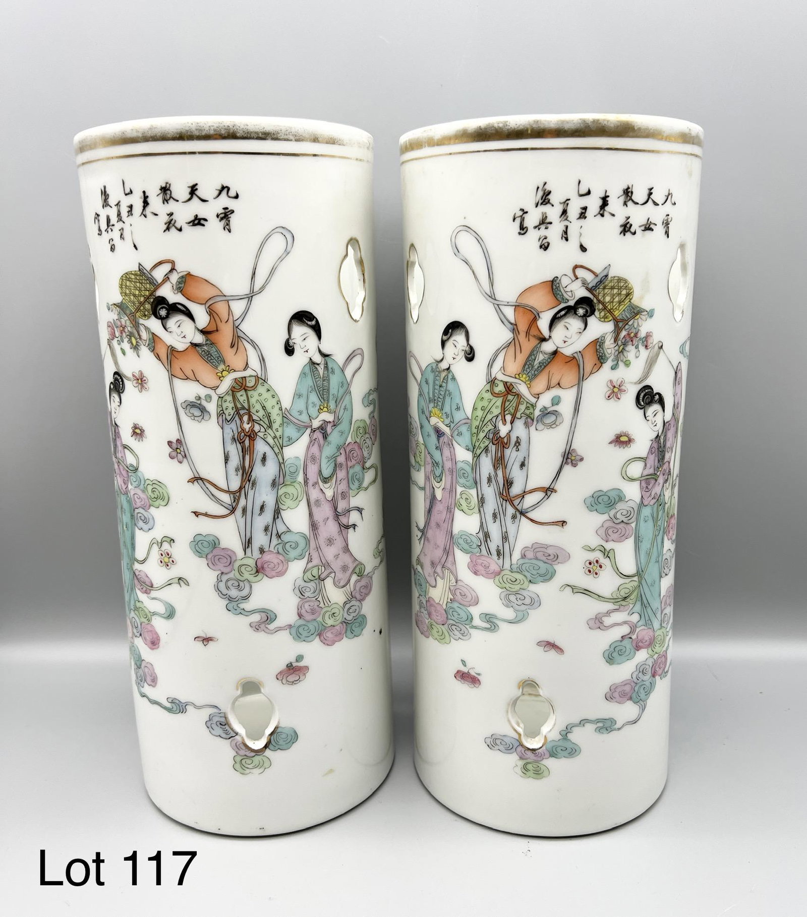 Pair of Mid 20th Century Chinese Porcelain Brush Pots / Hat Stands: A pair of Mid 20th Century Chinese brush pots or hat stands. Made of porcelain with enameled scene of women dancing with flowers falling around them. Both have cut out shapes throughout. Makers seal o