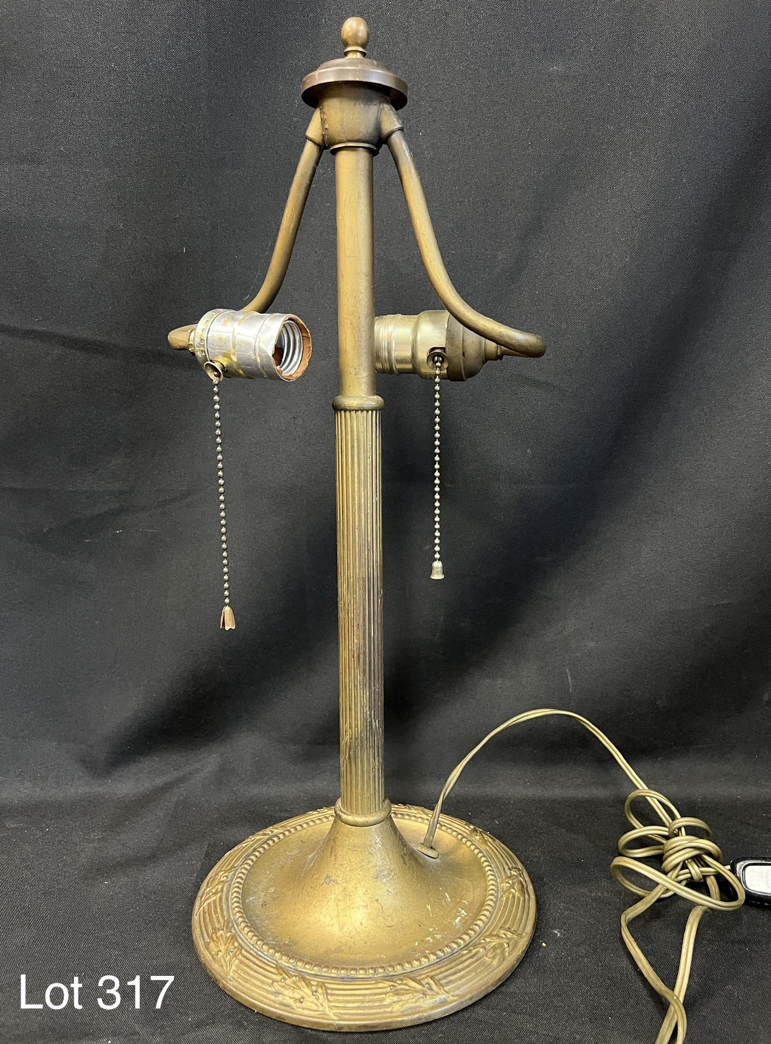 Antique Turn of the Century Bradley & Hubbard Brass Table Lamp: Brass table lamp by Bradley & Hubbard. Makers mark on the underside. Leaf design along edge of round base. Has two light fixtures on curled arms. Made at the beginning of 20th century. 19" tall. *note
