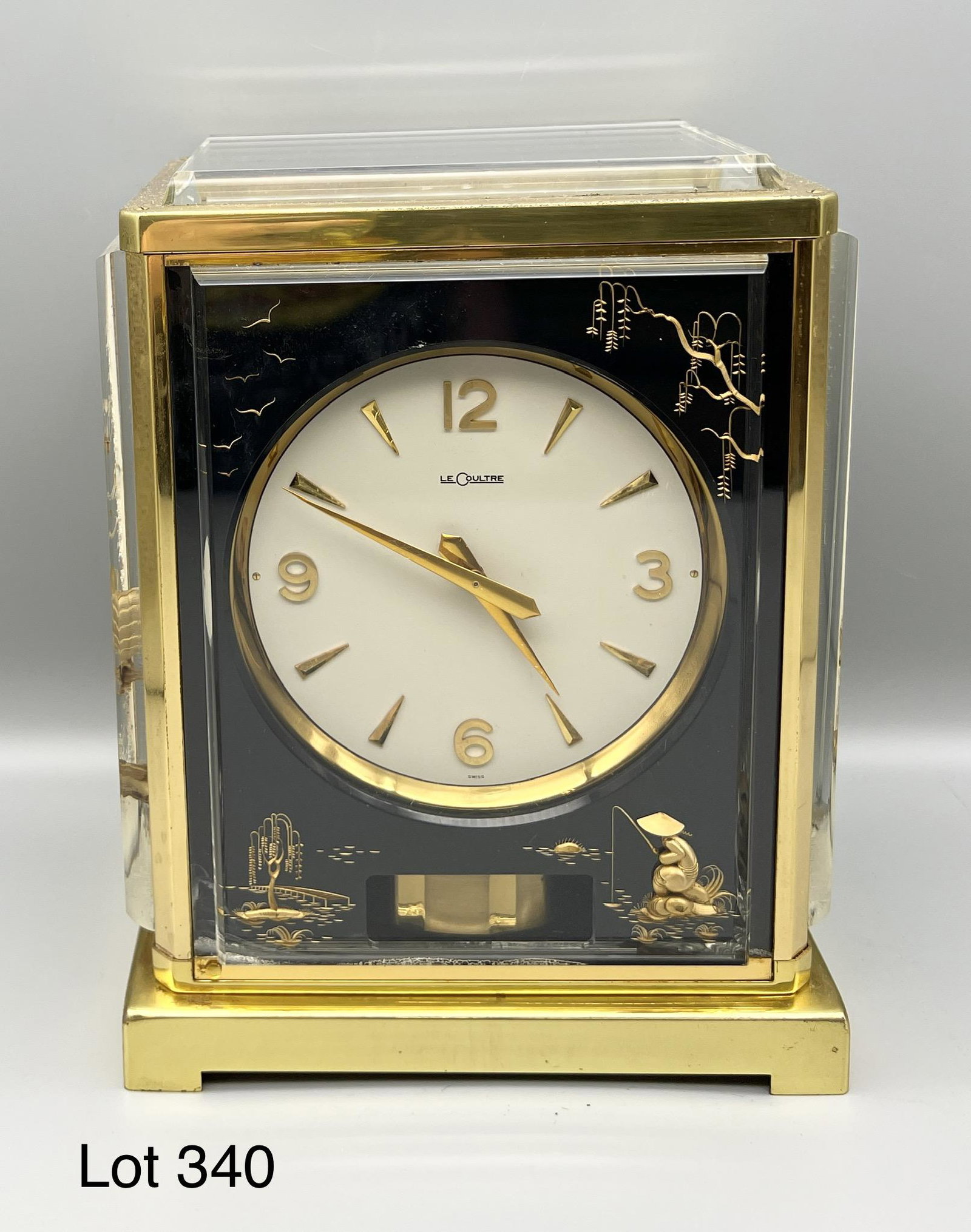 Mid Century Jaeger Lecoultre Atmos Marina Clock in a Japanese motif: A mid 20th century Jaeger Lecoultre Atmos Marina clock in a Japanese motif. This clock has beveled glass panels with gilt decoration against a black background. Brass base and edges. It has quarter ho