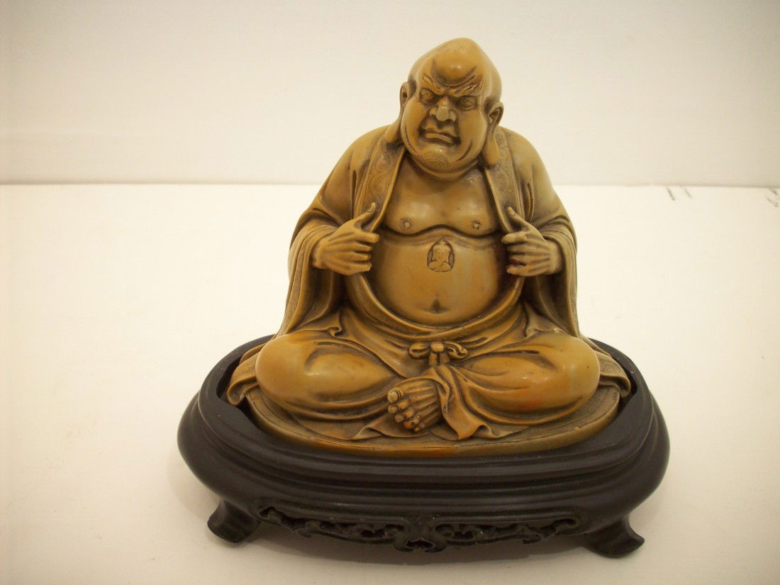 Soapstone Carving of Louhan: 5 1/4" X 5 5/8" x 3 1/8" with a 1 5/8" tall stand, China, Louhan sitting with his garment open exposing his belly, great green yellow color, fitted stand does not sit level, with presentation box