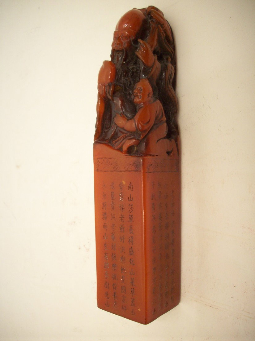 Red Soapstone Seal: 6" X 1 1/4' square, China, top carving of Old man and another kneeling, Chinese characters on all four sides, Excellent condition