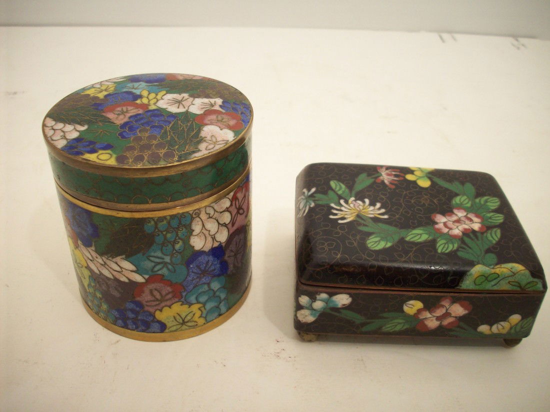 2 Oriental Enamel Lidded Tins: Round tin: 3 1/8" X 3" diameter, handpainted fruit and flowers. Square tin: 3 3/4" X 3" X 1 3/4" with a hinged lid, 4 footed, handpainted leaves and flowers. Both have that "cloisonné" appearance, bo