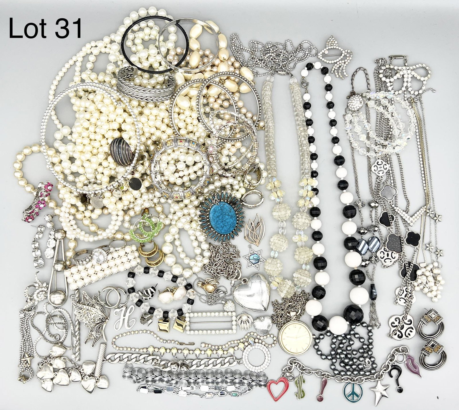 Mixed Variety of Costume Jewelry: A fine lot of costume jewelry featuring many faux pearl and silver necklaces. Also included are bracelets, rings and brooches. One strand of beads has broken closure.