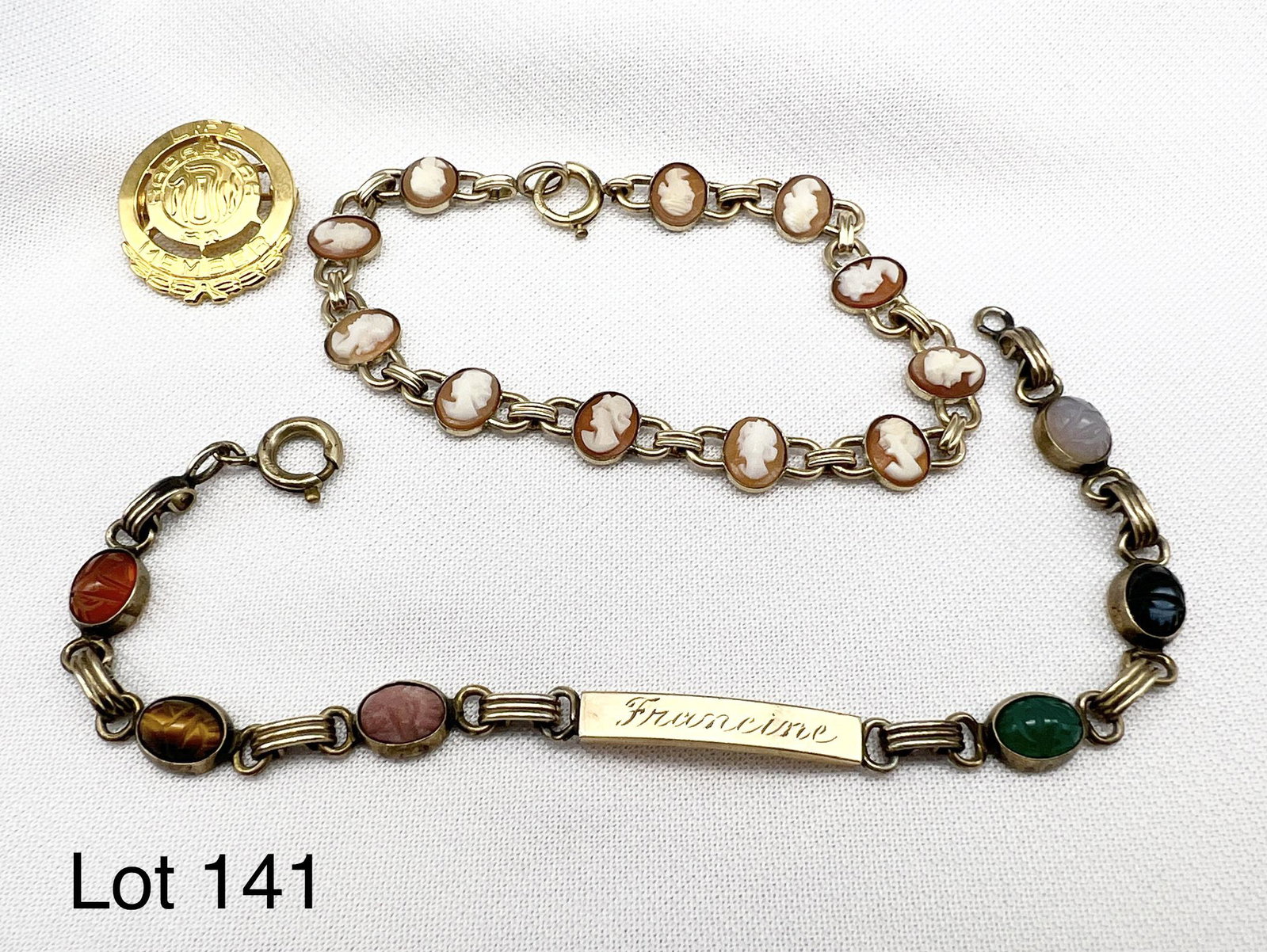 Lot of Gold Filled Jewelry: Selection of gold filled jewelry. Includes a cameo bracelet, a multi colored stone bracelet engraved with "Francine" and a vintage life Hadassah member pin.