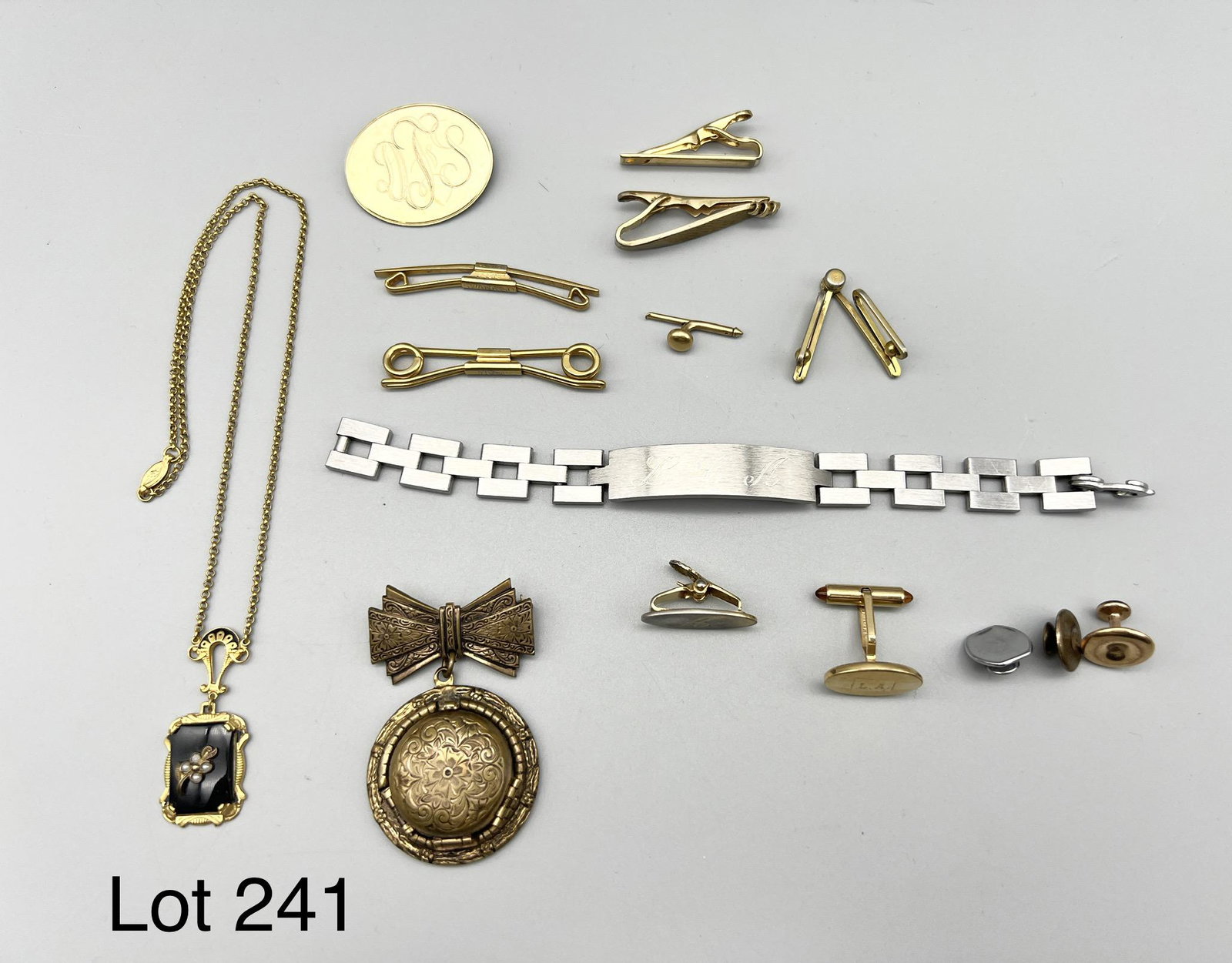 Collection of Vintage Costume Jewelry and Accessories: Collection of vintage costume jewelry and accessories. Includes collar clips, tie bars and cufflinks. Noteworthy items include a gold toned vintage pin with bow and hat locket. Locket opens to reveal 