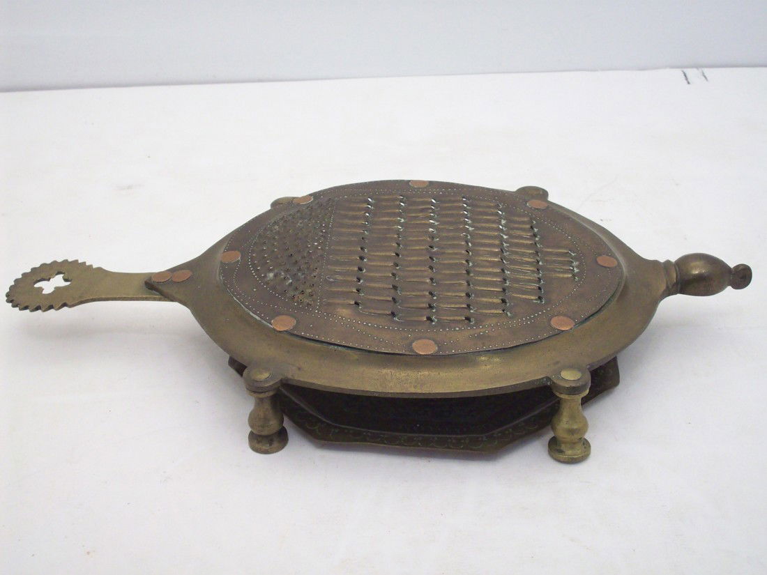 Indian Turtle Grater: 13" X 7" X 1 1/2", heavy grater in a turtle shape with an underplate, used condition with some residue on the underside