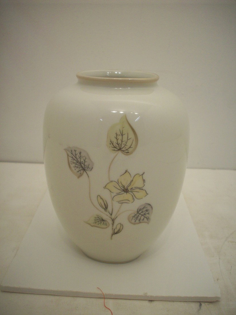 KPM Oval Vase: 6" X 4" widest, Cream colored with floral decorations, gold foot band and gold rim band with some loss, excellent condition with no chips or cracks