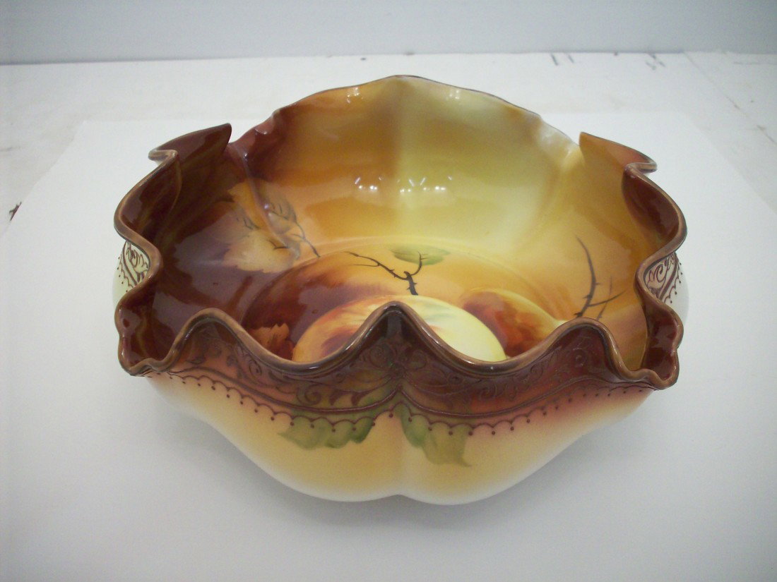 Handpainted Nippon Bowl: 3" X 8 1/4" widest, scalloped edge exterior rim banded patterens, interior has fruit and branches on a background of vivid fall colors, excellent condition