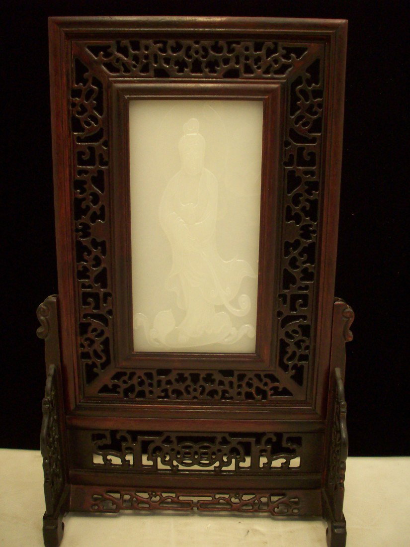 Rosewood Table Screen: China. 16 3/4" X 10 1/2" X 5", carved rosewood table screen with a 4 1/2" X 8" white jade-like material panel. Excellent condition with a presentation box