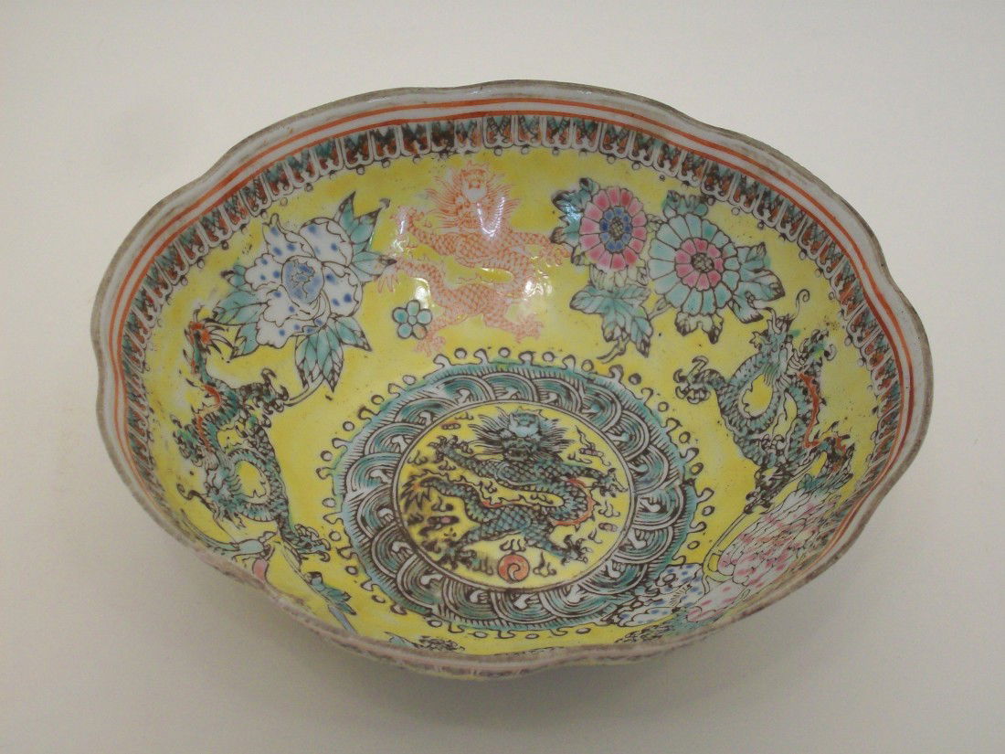Qing Dynasty Porcelain Dragon Bowl: 6 3/8" X 2", thin porcelain bowl with yellow background and 5 clawed dragons and flowers and patterned designs, chop marked, rim is unglazed and is rough, great condition