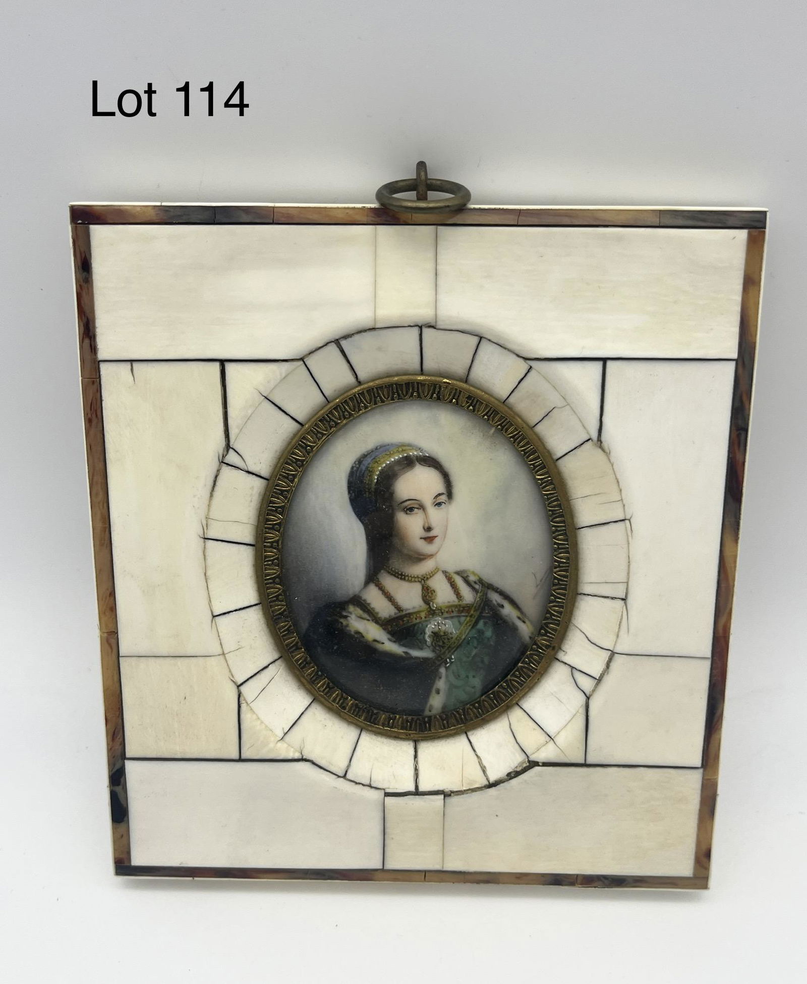 Porcelain Portrait in Bone Frame: A small-sized hand painted portrait on porcelain of a woman, all in bone frame with tortoise shell accent. Faint signature along right side. Measures 4 3/8" x 4 3/4". *note - marked "Jeanne Grey" on b