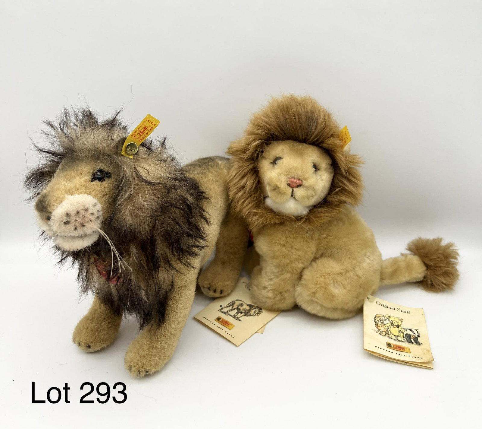 Pair of Steiff Lions: Duo of Steiff lion plushies. Includes a soft plush lion named "Snuffi" (#077180) and a slightly larger mohair lion (#066757). Both have all IDs attached. Made in Germany in late 1990s-early 2000s.
