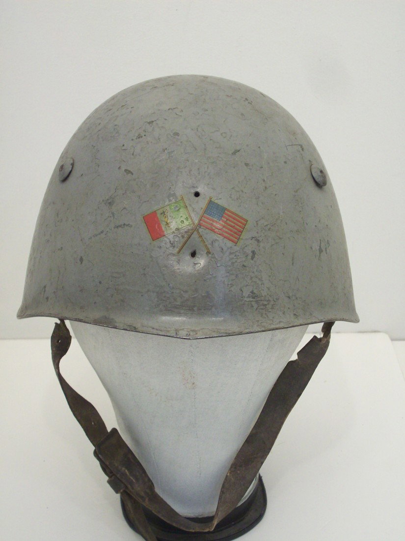 Italian WWII Helmet: WWII Issue Italian Model 33 (M-33) Steel Combat Helmet. Designed by Nicola Leszl for the Mussolini Government, front insignia replaced with crossed flags, band, liner and strap intact, grommets are lo