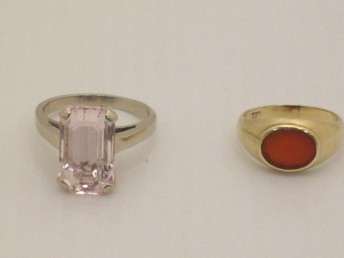 Lot of Gold Rings: Lot of two. 14Kt yellow gold pinky ring with carnelian stone, size 3. 14Kt white gold ring with pink topaz, size 6