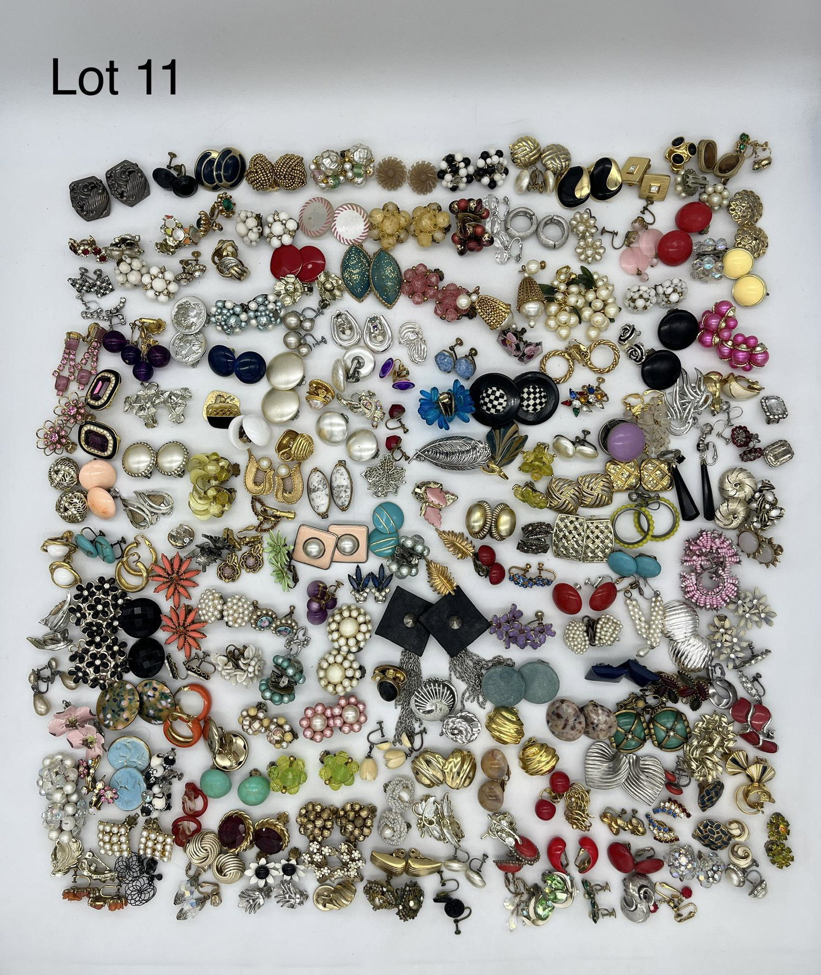 Group of Costume Clip-On and Screwback Earrings: An extensive group of costume clip on and screwback earrings for a variety of styles and looks, including some vintage pieces. A few are noted signed