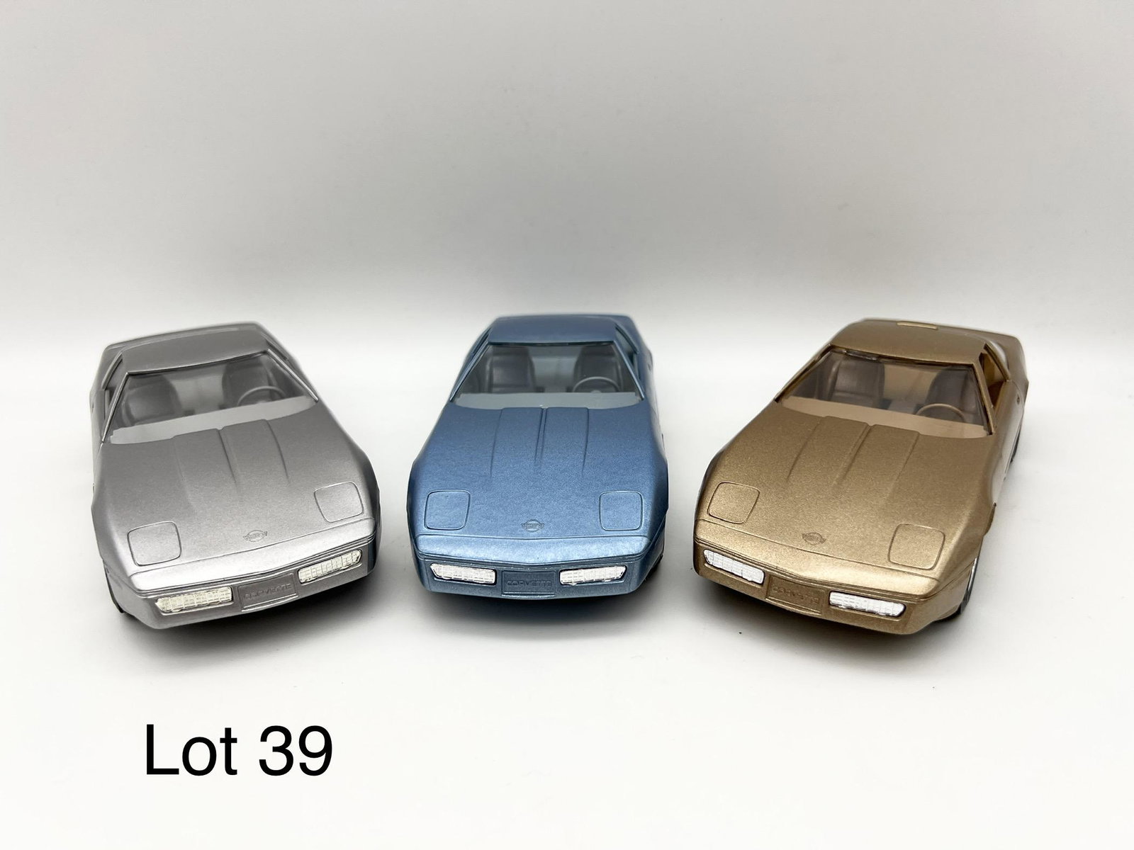 Trio of AMT-Ertl Model Corvettes: Lot of 3 AMT-Ertl promotional model corvettes from the 1980s. Includes a silver 1984 Corvette, a 1985 light blue Corvette and a 1986 gold Corvette. All in original boxes.