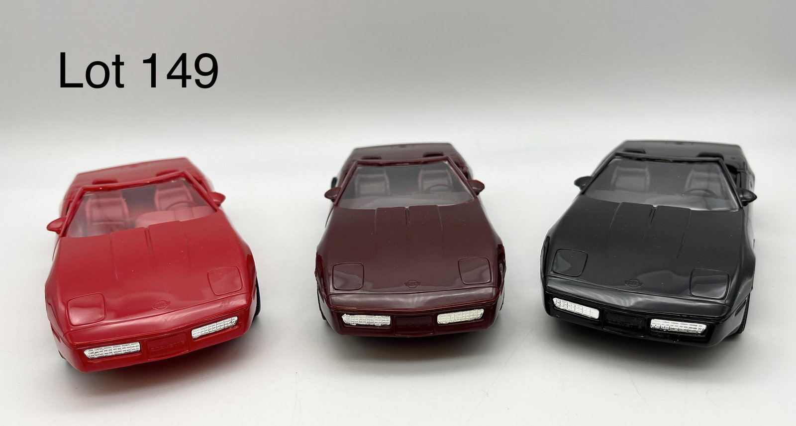 Trio of AMT-Ertl Late 1980s Model Corvettes: A trio of promotional model Chevrolet Corvettes by AMT-Ertl, all from the late 1980s and in box. Lot includes: one 1988 Dark Red Roaster #6095EO, one 1989 Black Convertible #6063EO, and one 1990 Brigh
