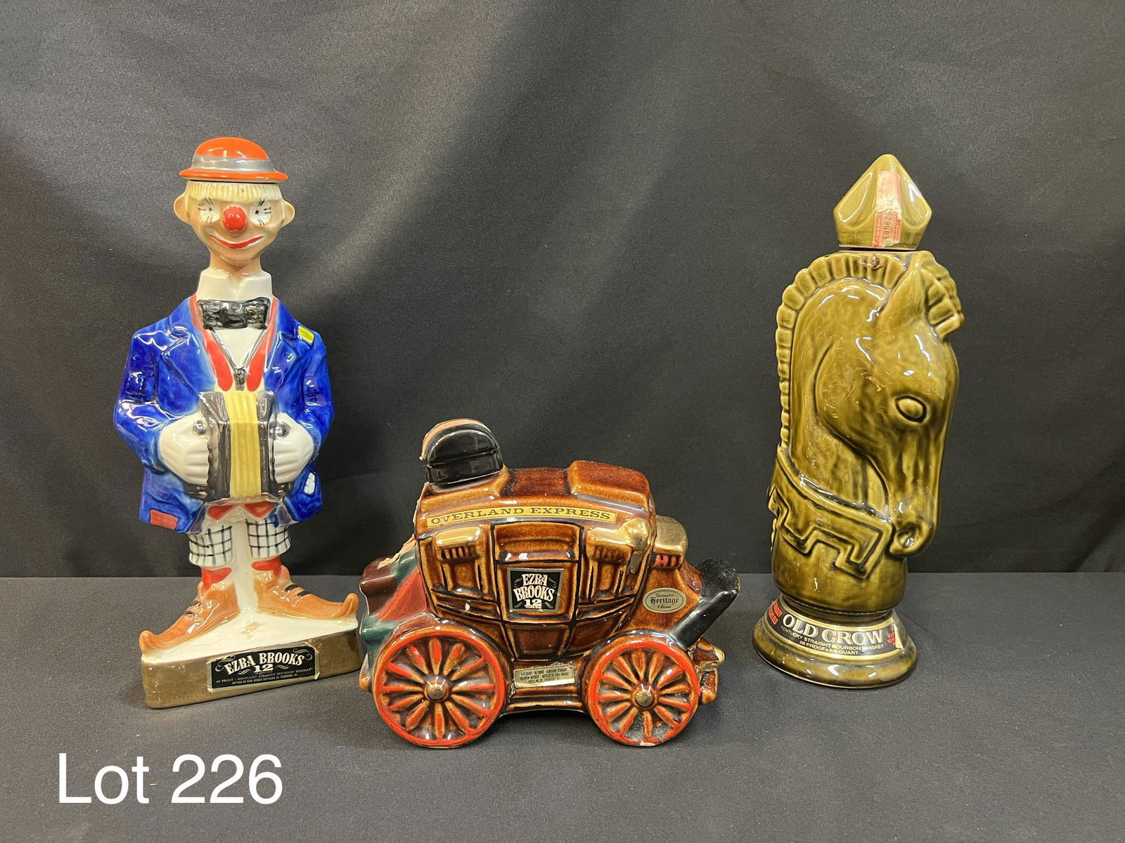 Trio of Vintage Liquor Decanters Including Ezra Brooks Bourbon: Group of 3 vintage liquor decanters. Includes an Old Crow Kentucky Straight Bourbon Whiskey decanter in the shape of a chess piece and two Ezra Brooks 12 year Kentucky Straight Bourbon Whiskey decante