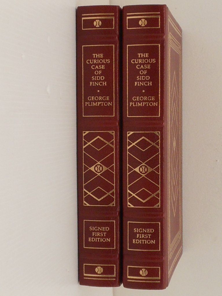 Franklin Mint Sealed 'The Curious Case of Sidd Finch': Lot of two. These 1987 first editions have been personally signed by the author George Plimpton. Each book has been bound in fine leather and printed on archival paper. Presented on the occasion of Ba