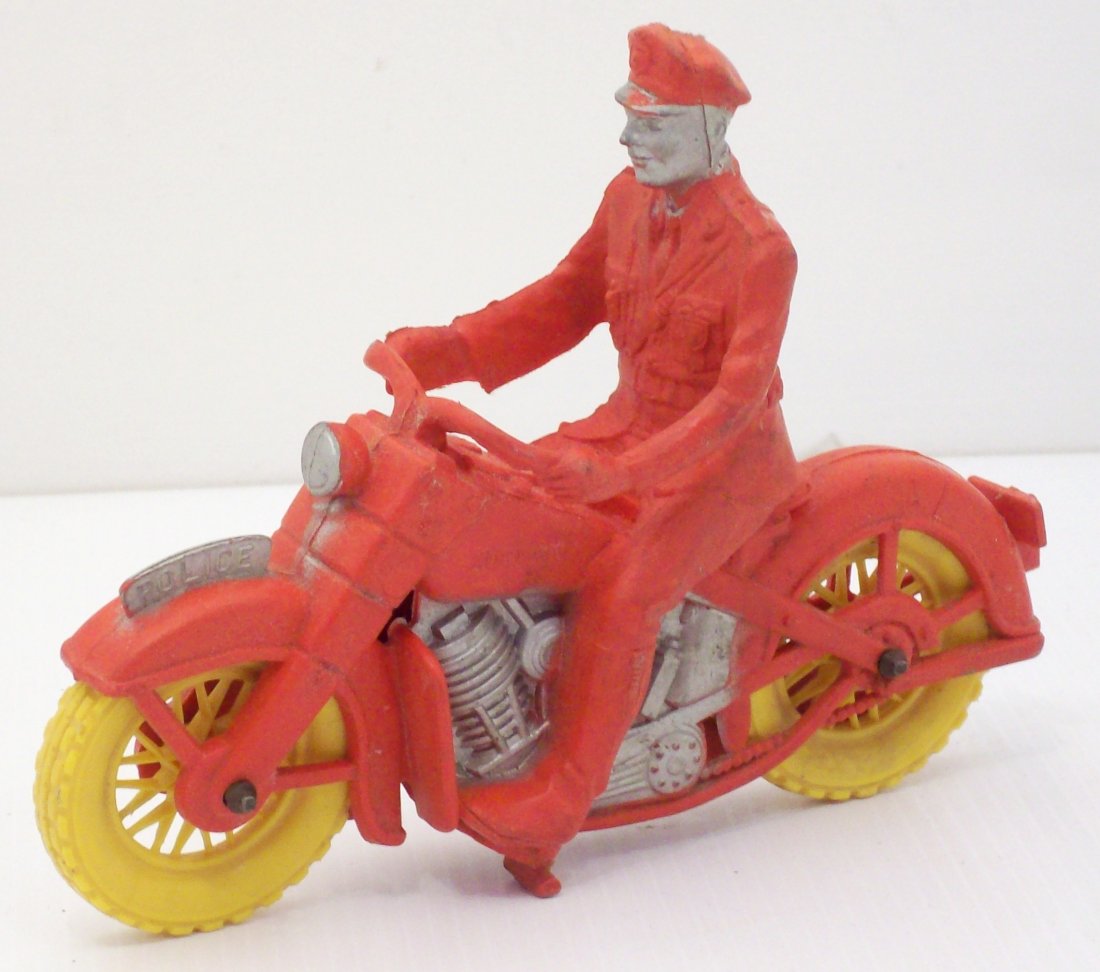 Vintage Auburn Toys Harley Davidson Police Motorcycle: 6" long X 4 3/4" tall X 1 3/4" wide, circa 1950's, red, silver and yellow, made of rubber like vinyl, functional, great condition
