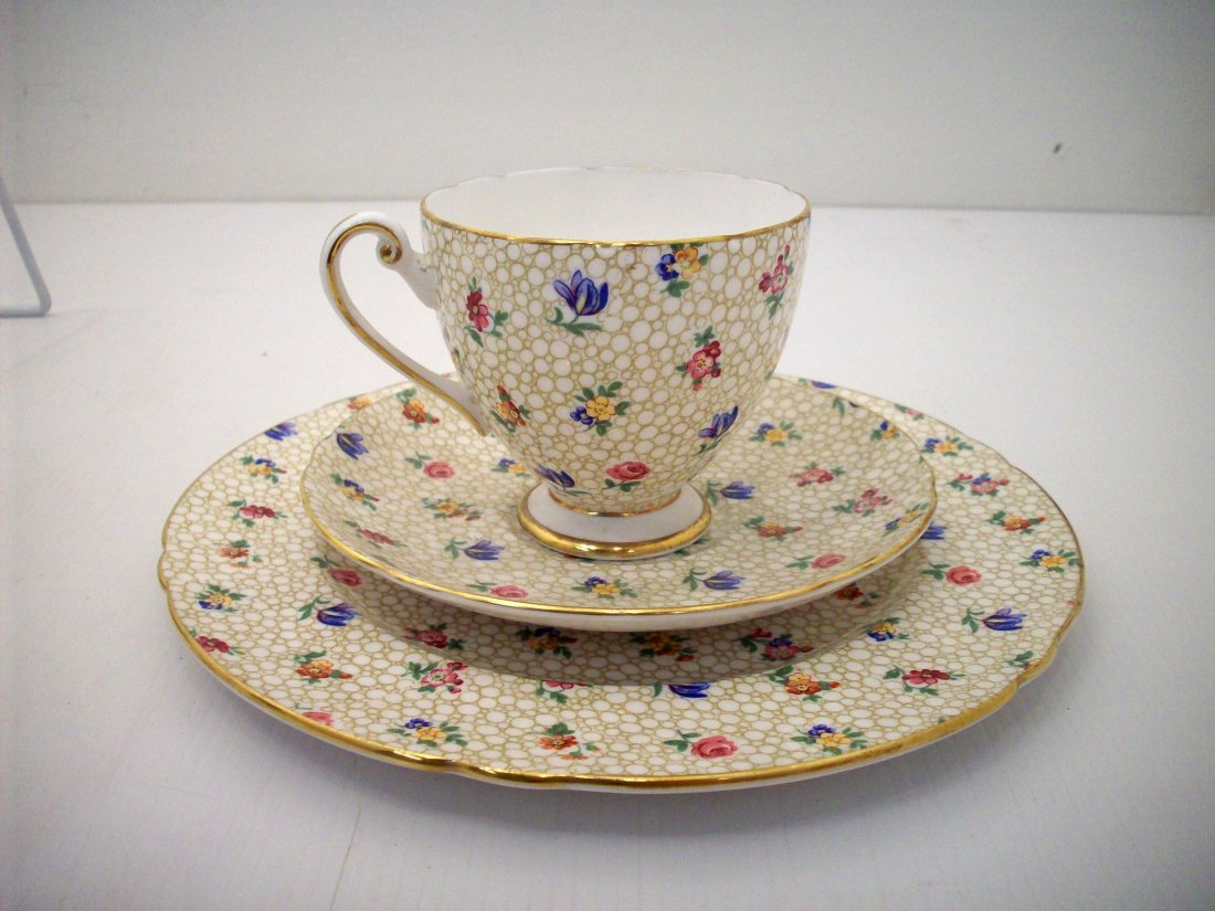 Shelley Floral Chintz Tea Cup Trio Set: Shelley China cup, saucer and plate set # 14274 in Floral Chintz . Ripon shape with gold trim. The cup is 3" high, the saucer is 5 3/4" and the plate is 8" in diameter with white interior and burnishe