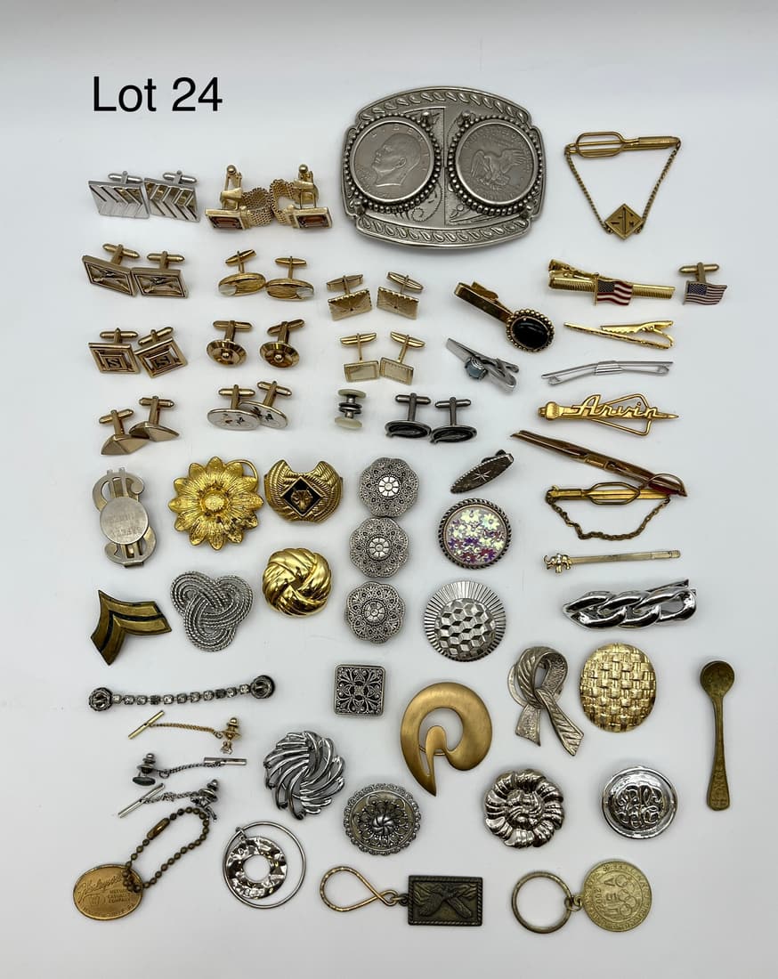 Mixed Lot of Costume Jewelry Featuring Men's Accessories: A mixed lot of costume jewelry and accessories with a focus on cufflinks and clips, though lot also includes a belt buckle, keychains, and more. Noted with some signed.