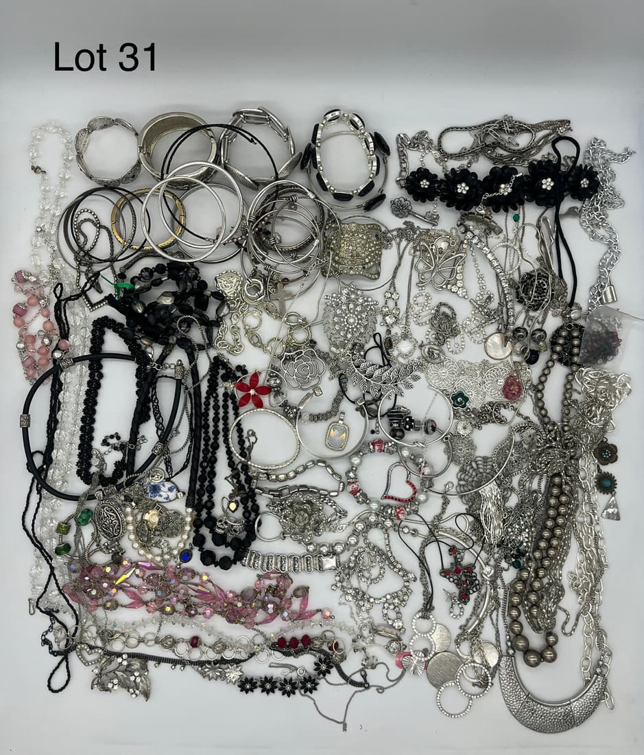Variety Lot of Evening Wear Jewelry in Silver and Dark Tones: A variety of evening wear jewelry in silver and dark tones with bracelets, necklaces, and pendants. Many show rhinestones or semiprecious stones.