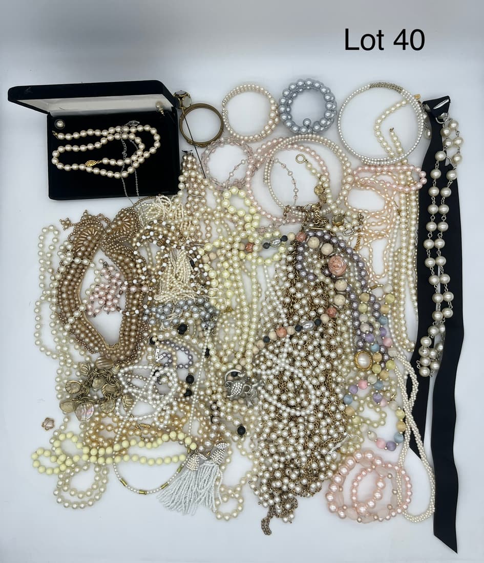 Elegant Collection of Costume Jewelry Featuring Faux Pearls: A lot of elegant costume jewelry with a focus on faux pearls and beads. Shows necklaces, bracelets, and pins.