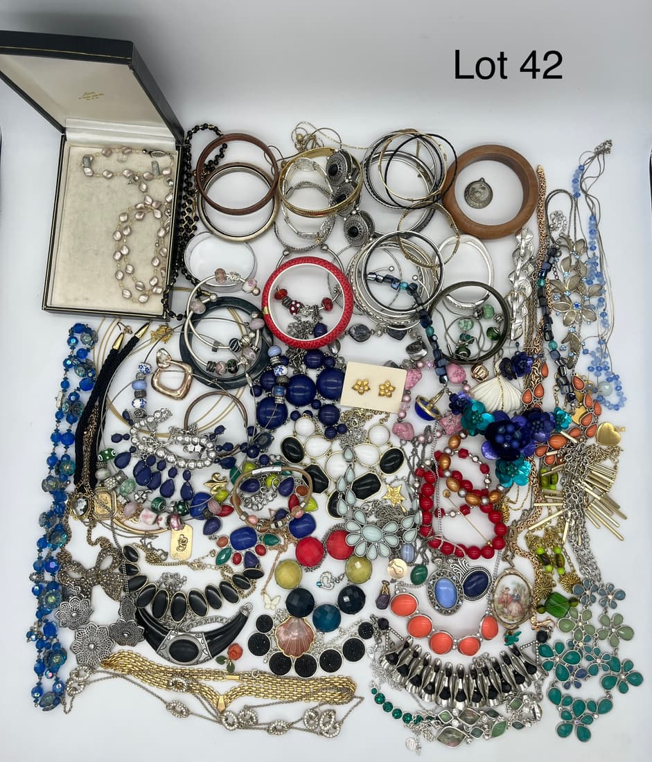 Colorful Lot of Costume Jewelry: A lot of unsigned costume jewelry in a prismatic variety of tones and shades, including stones, beads, and mixed metals. Lot shows a focus on statement necklaces and bangles.