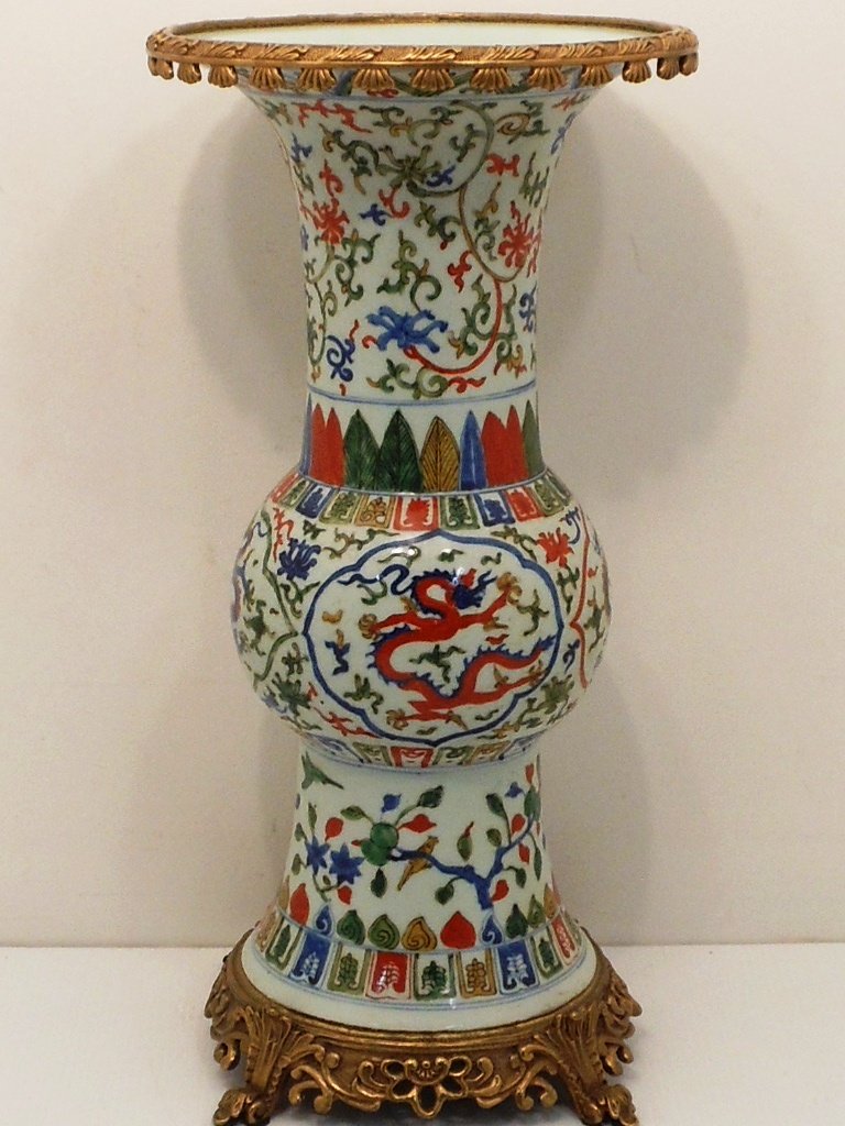 Antique Wucai Porcelain Yen Yen Vase: China, 18 1/4" X 9 1/2", Porcelain vase decorated with blue, red and green dragons surrounded with clouds and flames, birds and fruit trees, attached gold colored metal base and rim, great condition