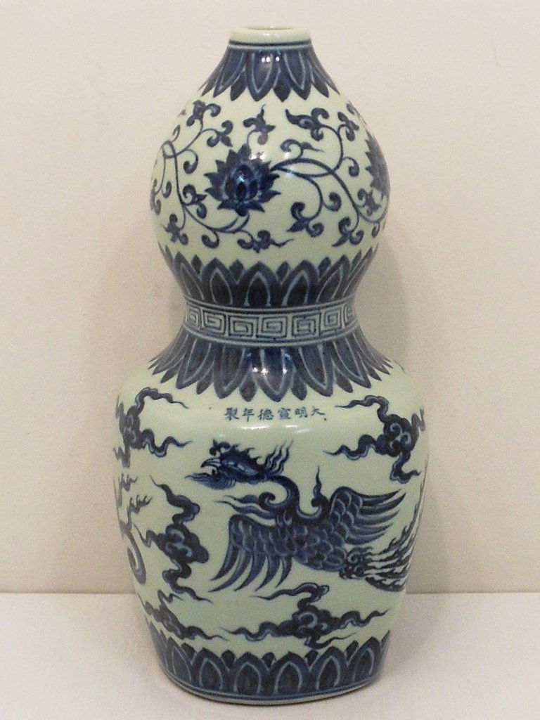 18-19th Century Blue and White Vase: China, 15" tall X 6 3/4" wide, porcelain rounded square base and bulbous upper, decorated with two Phoenixes in stylized clouds, bands and floral designs, marked on the side, excellent condition.