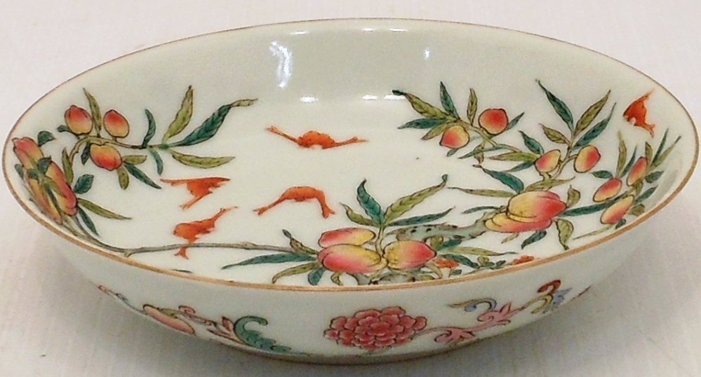 18th Century Famille Rose Plate #2: China, 1 1/8" tall X 4 7/8" diameter, porcelain plate decorated with a peach tree, peaches, and iron red bats above waves, floral designs on exterior, marked, excellent condition