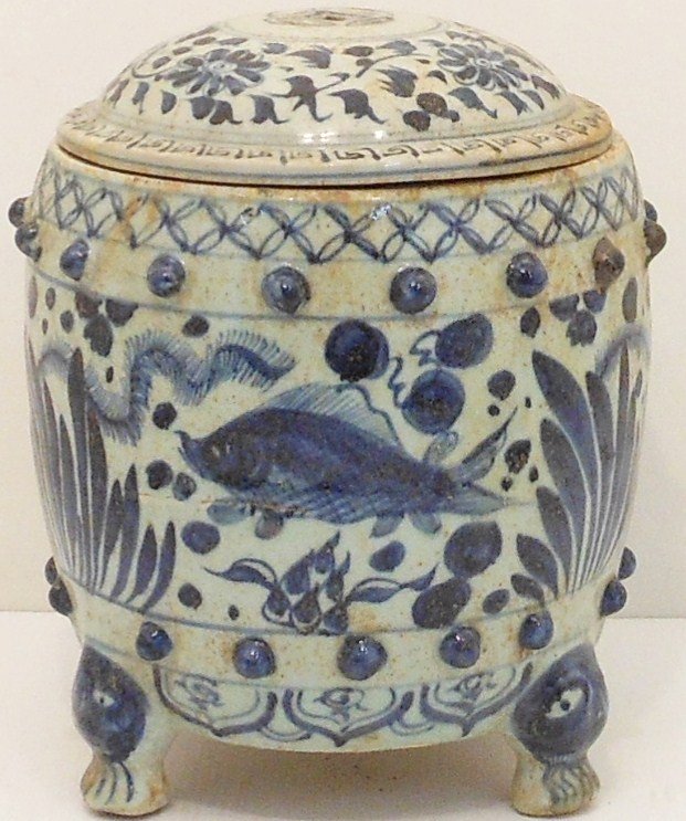 Blue and White Three-legged Jar: China, 9 3/4" tall X 7 3/4" wide, porcelain lidded jar, decorated with fish, plants, bands of floral and design patterns, three feet with faces, series of protruding decorations, lid has vent holes, h