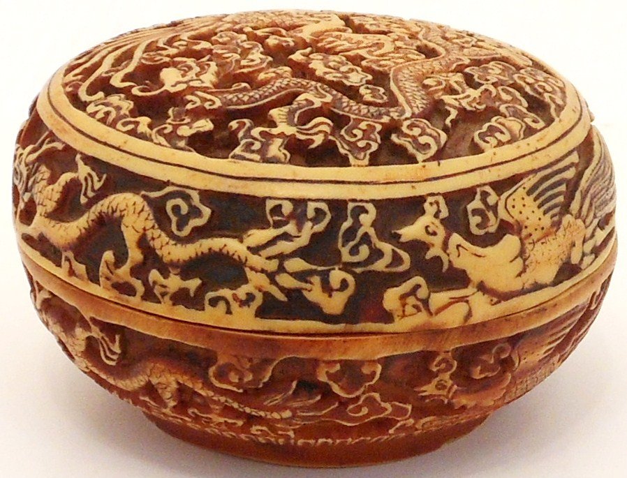 Carved Dragon Box: China, 1 5/8" tall X 3" diameter, carved Ivory like lidded round Dragon box, decorated with dragons and phoenixes in relief, unmarked, great condition carved slightly askew