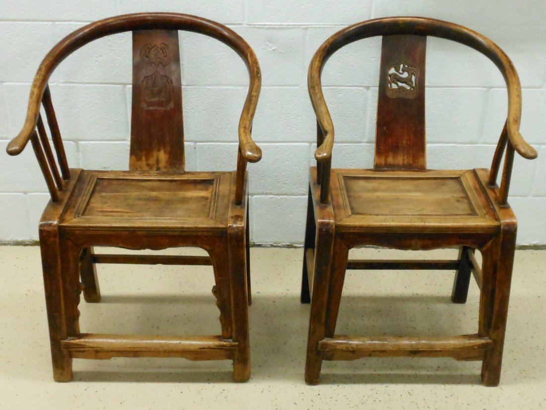 19th C. Pair of Huanghuali Horseshoe Back Armchairs: China, Pair of carved armchairs one is slightly larger than the other. Open work carved deer medallion on the back support chair is 36 1/4" X 23" X 22" with a plank seat, two arm spindles on each side