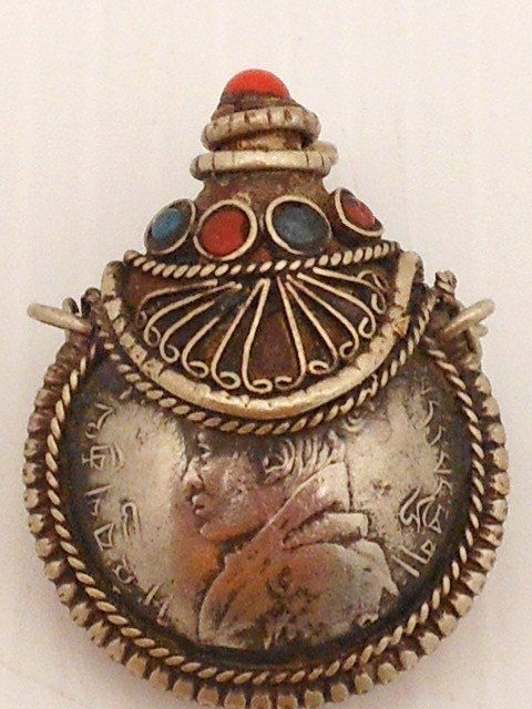 19th C. Oriental Silver Snuff Bottle: 1 3/8" Oriental Silver snuff bottle with a portrait on one side and the other characters and designs, decorated with blue and red stones, lid is topped red stone and is attached with a fine chain, gre