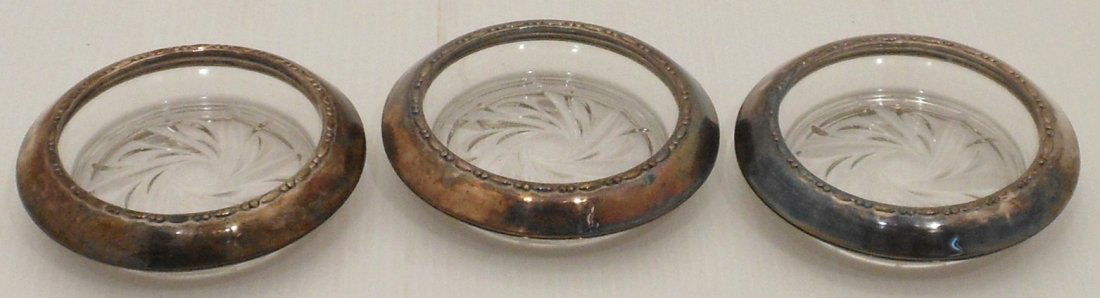 Sterling Rimmed Glass Coasters: Set of three Armston 4" sterling rimmed coasters. Used condition with patina.
