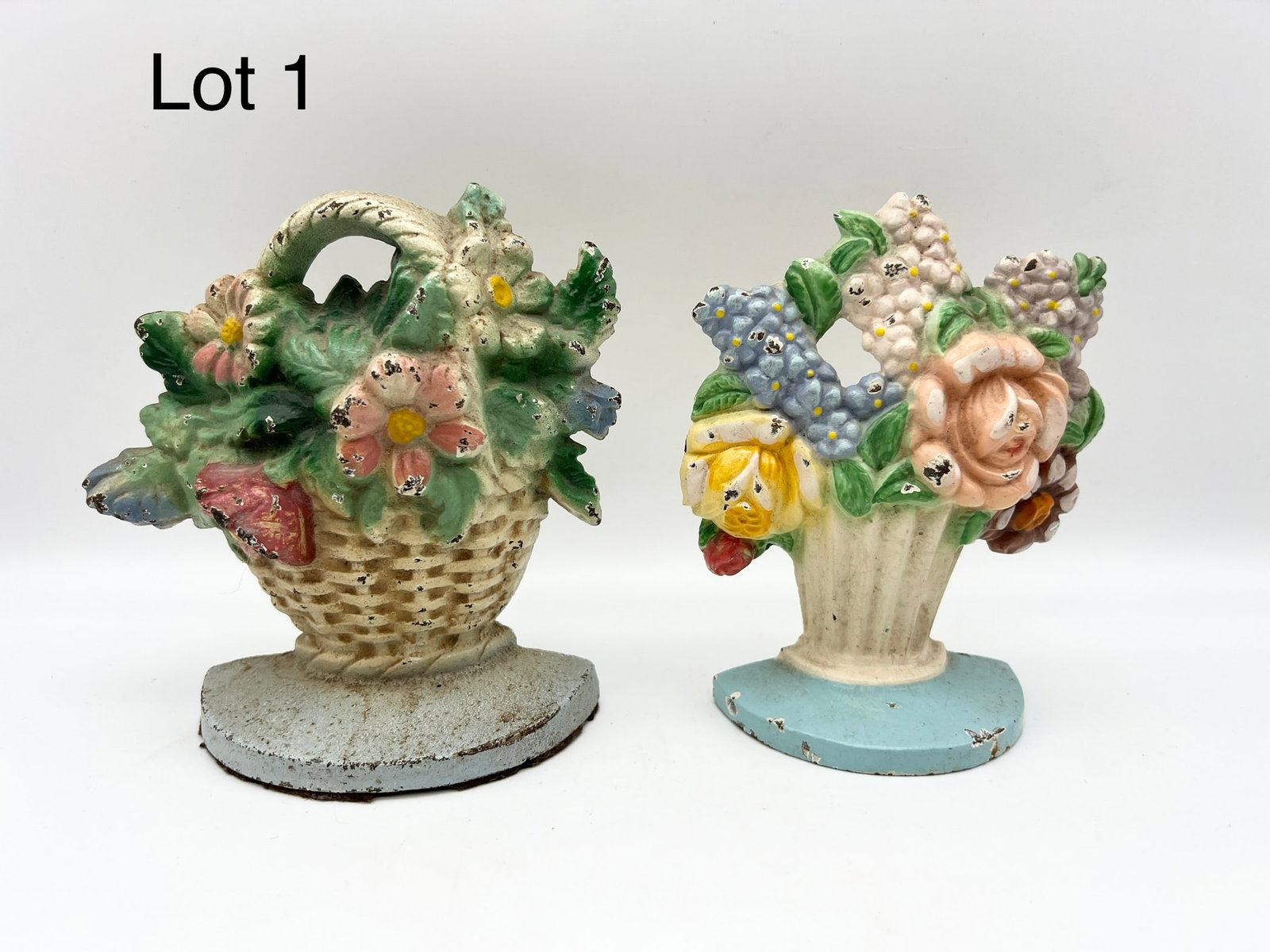 Pair of Vintage Hubley Flower Bouquet Door Stops: Lot of two painted cast iron flower bouquet door stops by Hubley. Both are 6" tall. *notes- paint loss on both